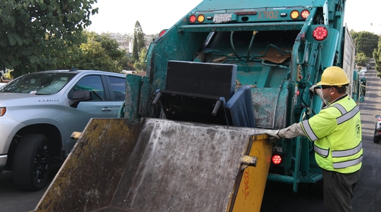 image of a trash truck picking up a bulky item