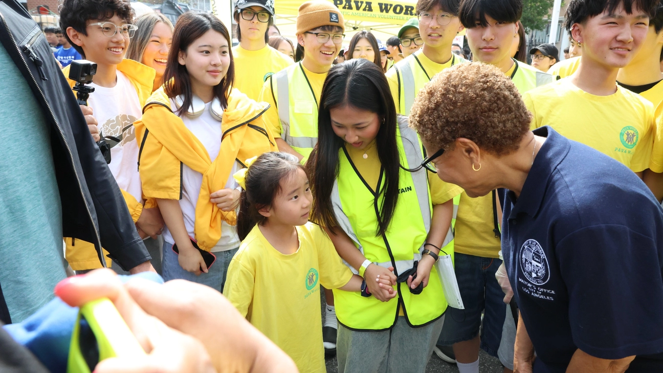 Mayor Karen Bass speaking to a young girl part of PAVA World at a Shine LA Event