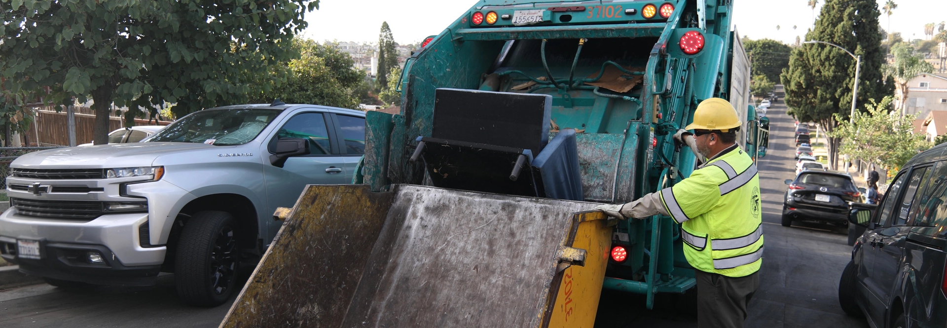 image of a trash truck picking up a bulky item