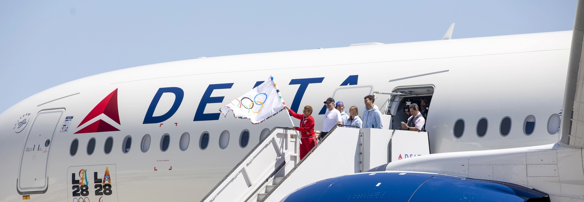 OLYMPIC FLAG LANDS AT LAX